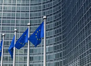 EU flags outside a large building